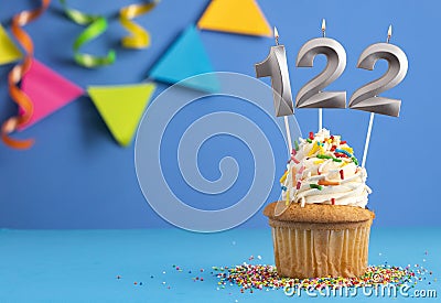 Candle number 122 - Cake birthday in blue background Stock Photo