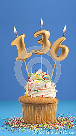 Candle number 136 - Cupcake birthday in blue background Stock Photo