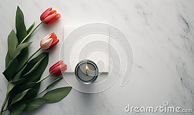 a candle and some tulips on a marble surface Stock Photo