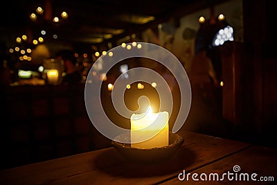 Candle on a table in a medieval tavern. Stock Photo