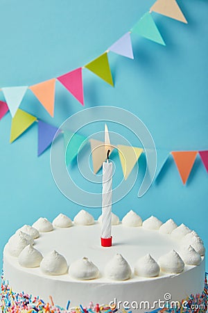 Candle on tasty birthday cake on blue background Stock Photo