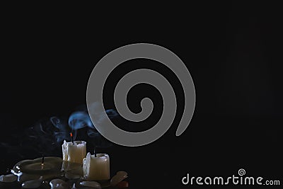 Candles blow off with smoke. Small, almost completely burnt candles. In the corner of the frame. Place for text Stock Photo