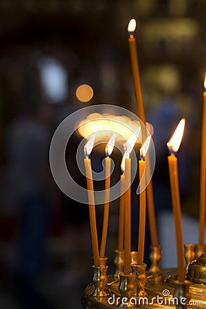Burning church candles. Bright fire. The atmosphere in the church. Stock Photo