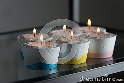 Candles in a differen colours concrete candle holders Stock Photo