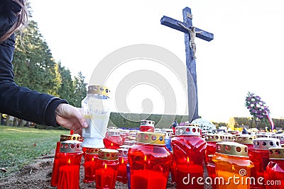 Candles on floor beneath cross Stock Photo