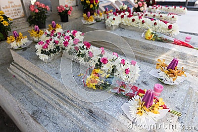 Candles and Flowers over Grave in The Annual Blessing of Graves at Ratchaburi Province, Thailand Stock Photo