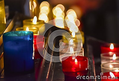 Candles inside a church. Sensation of religiosity and tranquility. Bokeh lights as space for text Stock Photo
