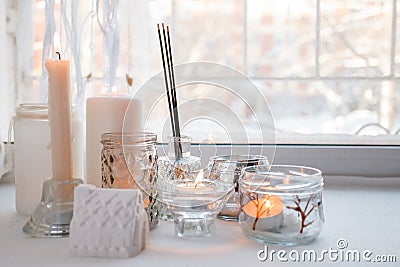 Candles with lights. composition on the windowsill. cute home decor with candles and aroma stick. Calmness relax, unplug, Stock Photo