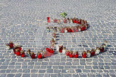 Candles on the street arranged in the shape of a symbol of Warsaw Uprising in 1944 Stock Photo