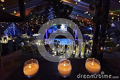 Candles and tulip flowers decoration at night, indoor luxury wedding with low light romantic ambient Stock Photo