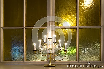 Candlestick on window ledge Stock Photo