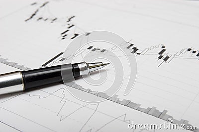 Candlesticks chart and pen Stock Photo