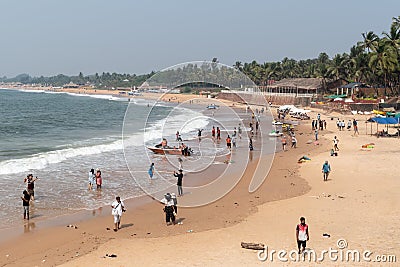 A female worker carrying a sack of trash at the popular tourist site of Fort Aguada in Editorial Stock Photo