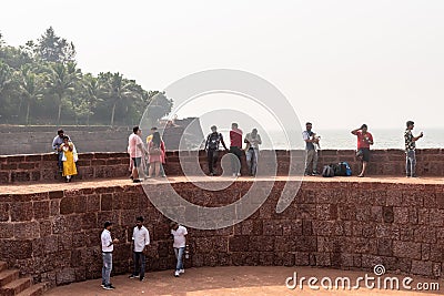 Large group of Indian tourists enjoying the view of the sea on the walls of the ancient Editorial Stock Photo