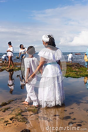 Candomble members and supporters are on Rio Vermelho beach offering gifts to Yemanja Editorial Stock Photo