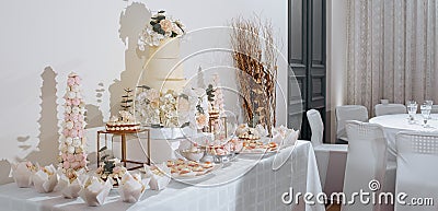 Candy bar at the banquet. Wedding table with sweets, cake, pastries, muffins, sugar treats. Event in the restaurant Stock Photo