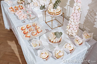 Candy bar at the banquet. Wedding table with sweets cake pastries muffins sugar treats. Event in the restaurant Stock Photo