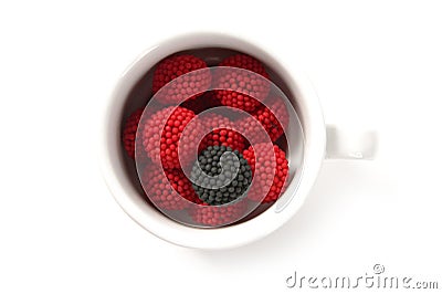 Candy berries and different black in a coffe cup Stock Photo