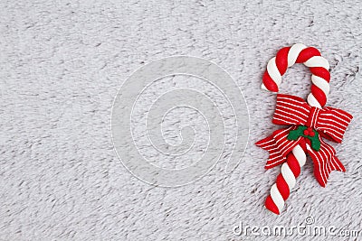 Candy cane on plush gray material background Stock Photo