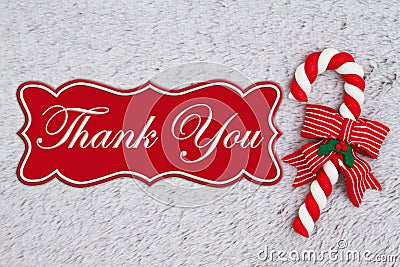 Candy cane on plush gray material with text Thank You Stock Photo