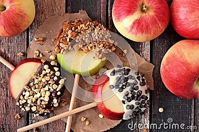 Candy dipped apple rounds, above on wood Stock Photo