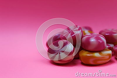 Sweet candy caramel on a pink background piled in a pile Stock Photo