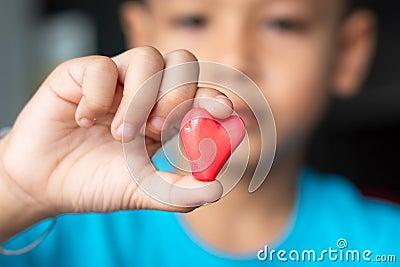 Candy red heart in hand a boy. Stock Photo