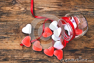 Candy shape heart in glass jar on wooden table Stock Photo