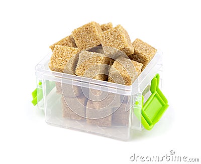 Cane brown sugar isolated on a white background. Cane sugar in a container. Plastic container with cane sugar Stock Photo