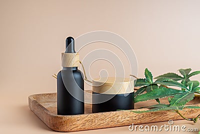 Cannabis face cream and serum or oil dropper concept. Natural cosmetic. CBD oil, THC tincture and hemp leaves on a Stock Photo