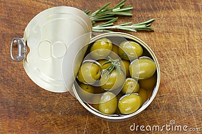 Canned green olives with rosemary Stock Photo