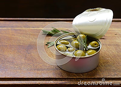 Canned green olives with rosemary Stock Photo