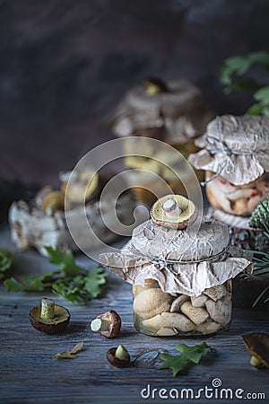 Canned mushrooms in a glass jar on the table Stock Photo
