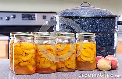 Canned peaches with large pot or canner Stock Photo