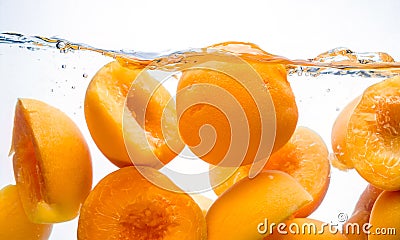 Canned peaches. Preserved fruit splash in water Stock Photo