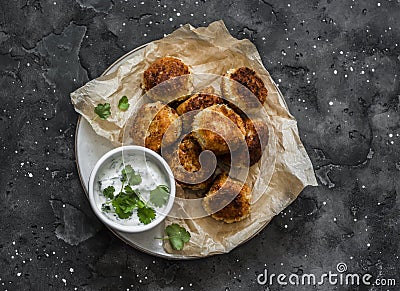 Canned tuna potato fish balls with greek yogurt cilantro sauce on dark background, top view Stock Photo