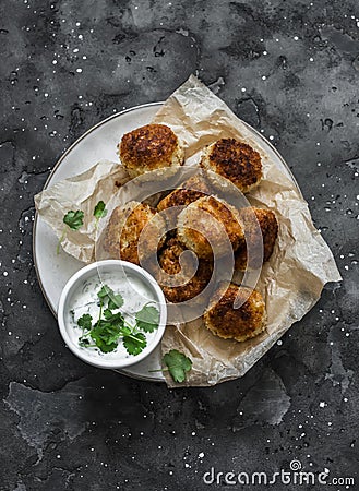 Canned tuna potato fish balls with greek yogurt cilantro sauce on dark background, top view Stock Photo