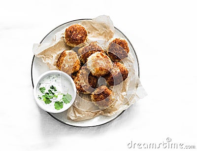 Canned tuna potato fish balls with greek yogurt cilantro sauce on light background, top view Stock Photo