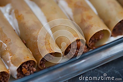 Cannelloni Pasta Unkooked. food Preparing. Bechamelle Sauce over Meat Cannelonni. Italian Traditional food. Stock Photo