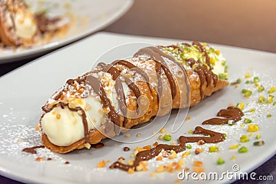 Cannoli italian cake with pistachios and chocolate, close up Stock Photo