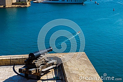 A cannon firing at a boat. Humour concept. Valletta Malta Stock Photo