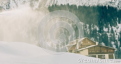 Cannon snow jet thrown over a cabin Stock Photo