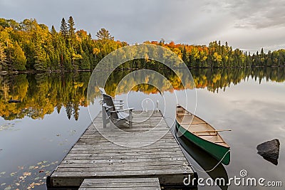 Canoe and Dock on an Autumn Lake - Ontario, Canada Stock Photo