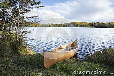 Canoe on the shore of a northern Minnesota lake during autumn Stock Photo