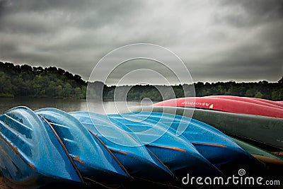 Canoes on the beach at stormy lake Editorial Stock Photo