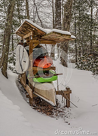 Canoes and other paddling boats wait through a long, snowy winter for a warm, spring day Stock Photo