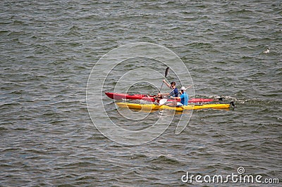 Canoes with unidentified people rowing in the sea Editorial Stock Photo