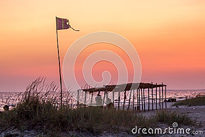 Canopy and flag on a wild beach Stock Photo