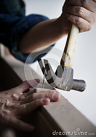 Canpenter using hammer pull a nail out from a wood Stock Photo