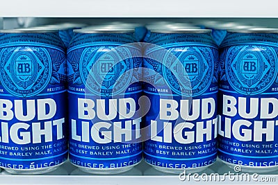 Cans of Bud Light Beer lined up on a shelf in a refrigerator. Editorial Stock Photo